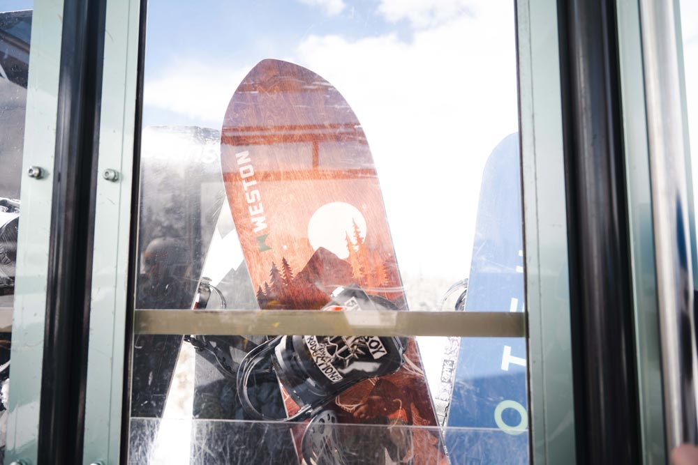 Weston backwoods snowboard leaning up against a ski resort gondola window