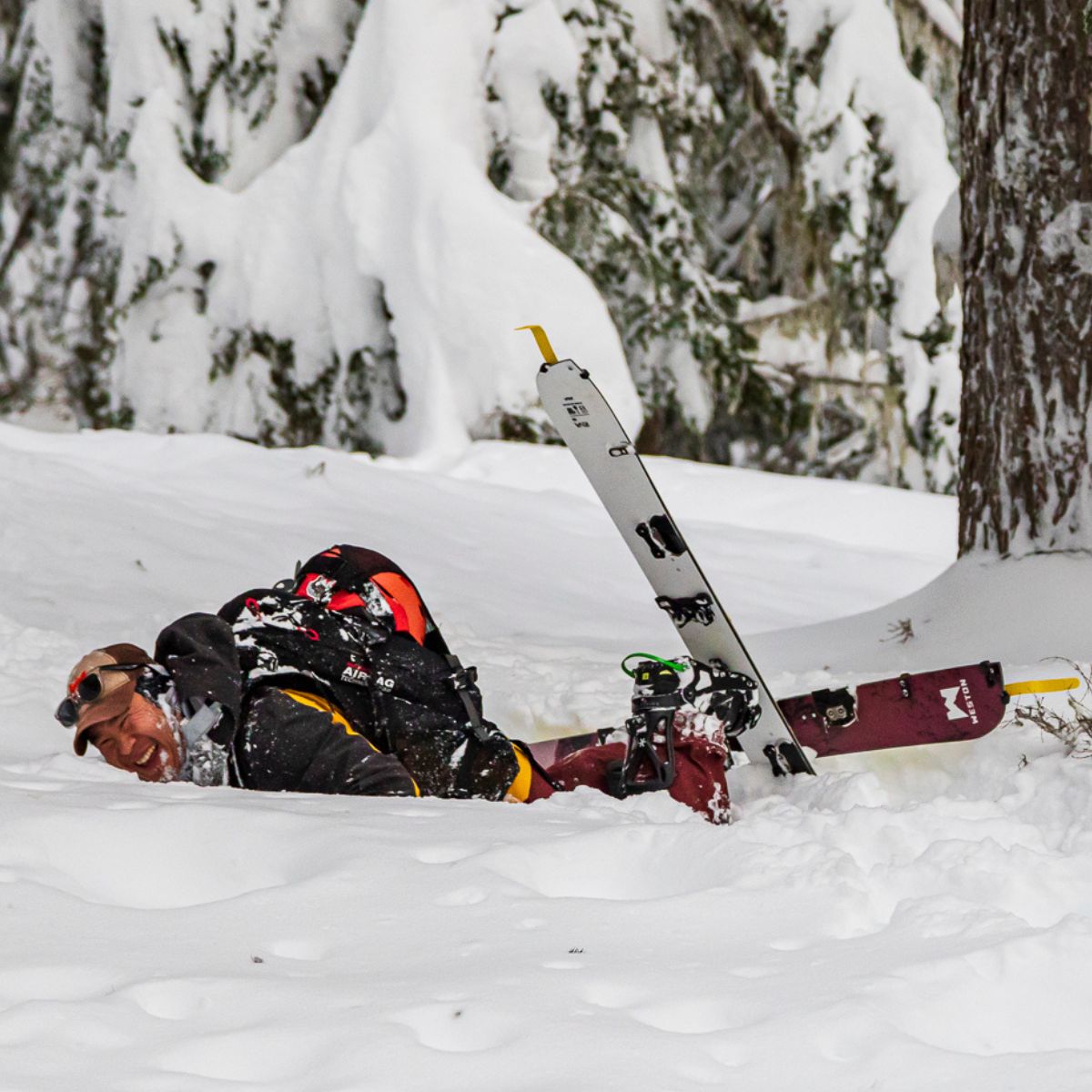 backcountry splitboarder falling into the snow on the weston riva splitboard