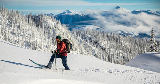 Backcountry Splitboarder on a Weston splitboard touring up a snowy mountain ridge in Revelstoke 
