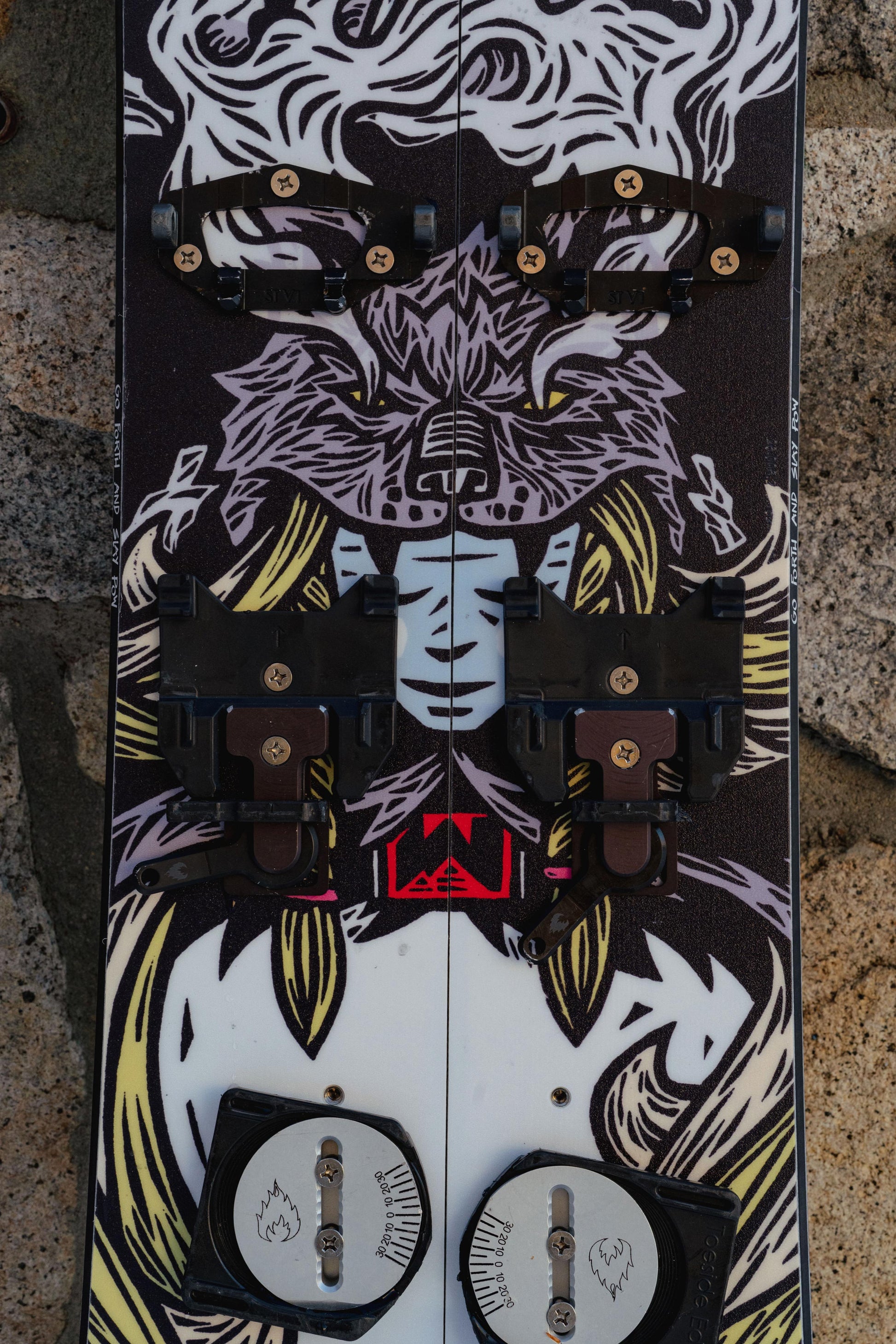 Close-up of the Weston Gnarnia Splitboard with a Viking woman wearing a wolf headpiece design against a rock wall background 